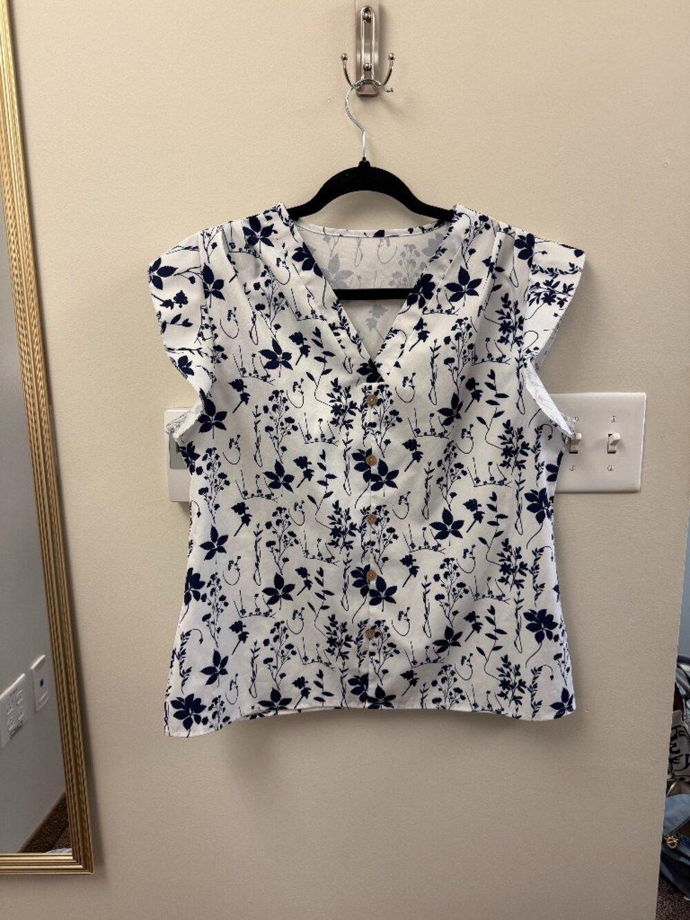 white blouse with navy floral pattern